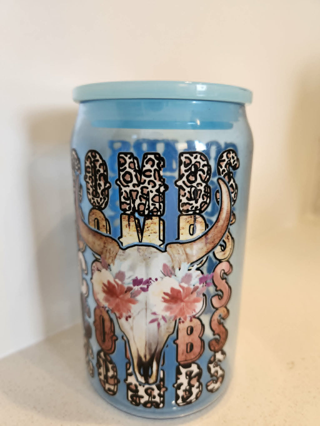 Luke Combs acrylic Libby cup - front view showing COMBS leopard print lettering with floral longhorn skull on baby blue