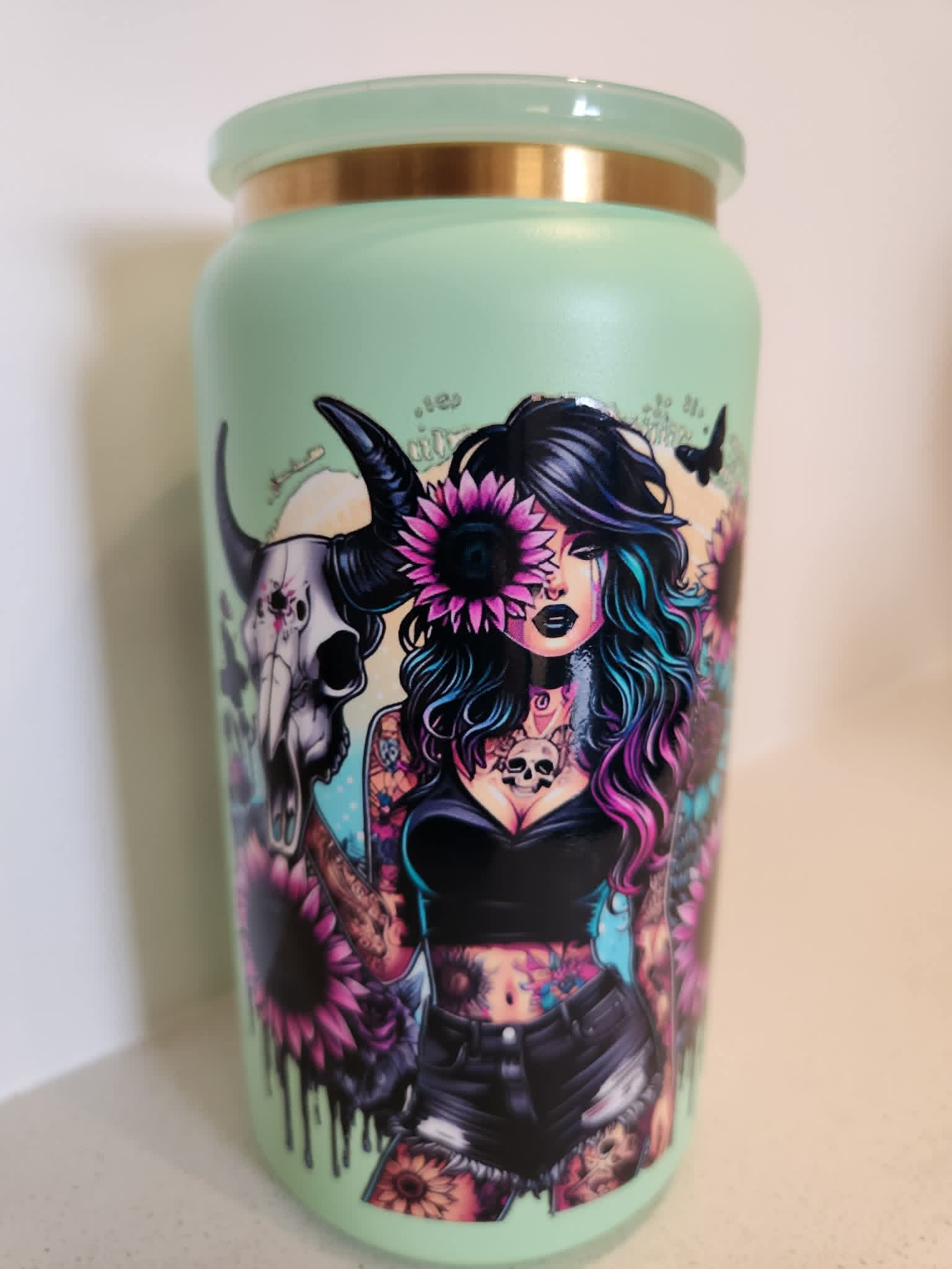 You Are Stronger Than The Storm stainless steel Libby cup - front view showing tattooed woman with bull skull and pink sunflowers