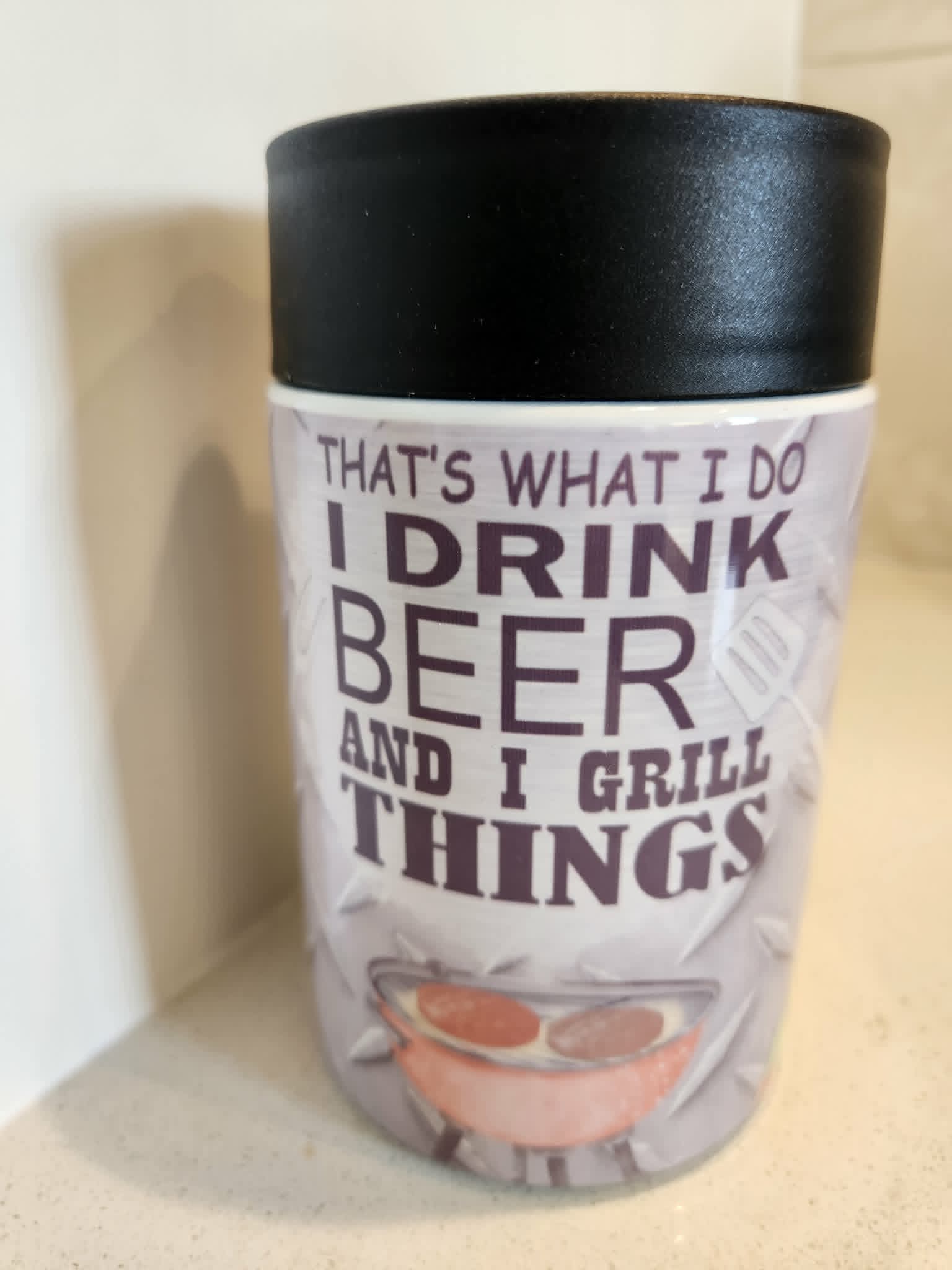 I Drink Beer And I Grill Things can cooler - front view showing bold black typography with BBQ grill illustration