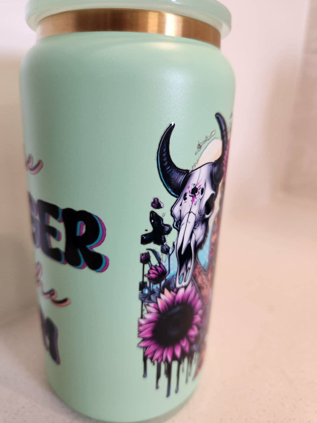 You Are Stronger Than The Storm stainless steel Libby cup - side view showing bull skull with sunflowers and butterflies