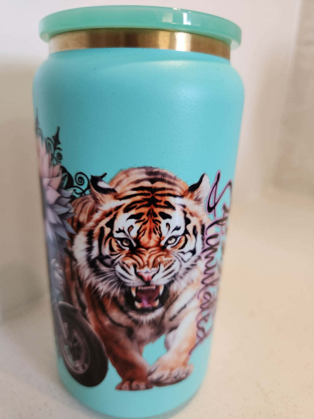 Over Stimulated stainless steel Libby cup - tiger side showing roaring tiger on teal background