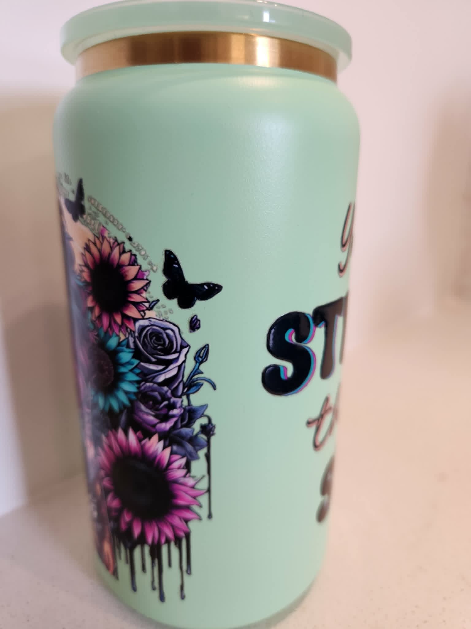 You Are Stronger Than The Storm stainless steel Libby cup - side view showing purple roses and pink sunflowers with butterflies