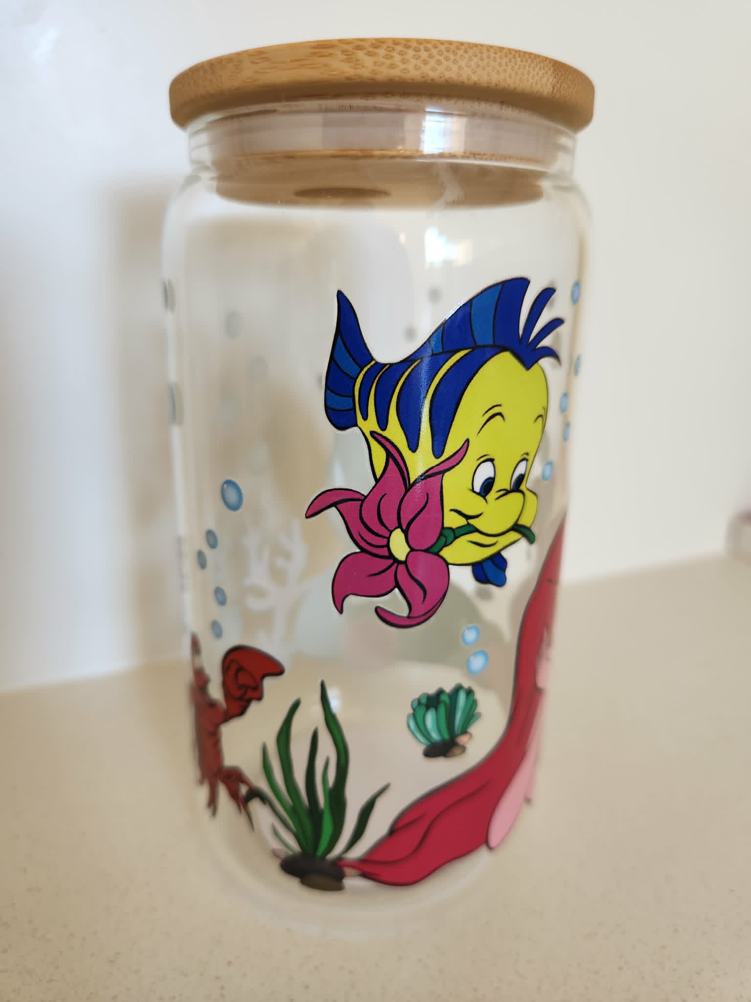 16oz Glass Libby Cup - Little Mermaid design with Flounder holding a pink flower